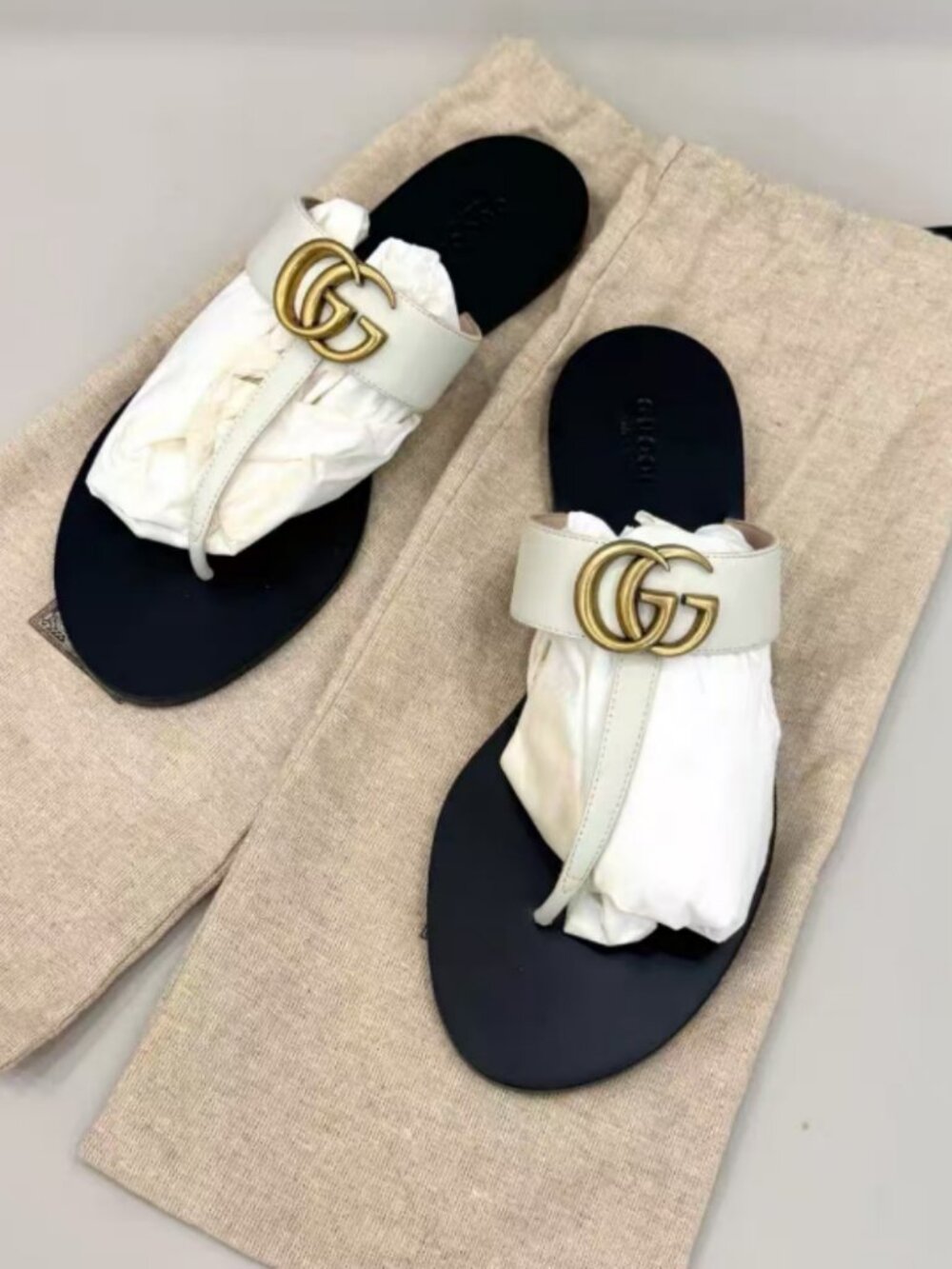 White leather thong sandals with gold-tone logo detail
